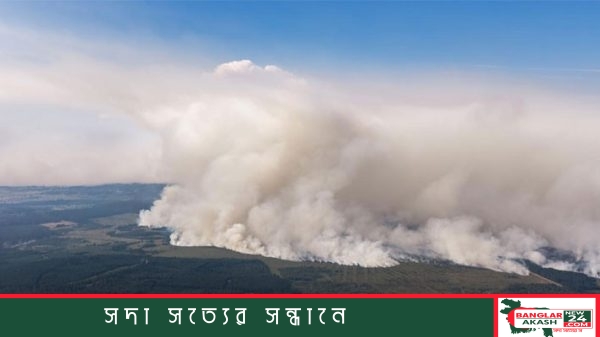 বেলজিয়ামের হাই ফেনস বনাঞ্চলে দাবানল নেভাতে হেলিকপ্টার ও দমকলকর্মীদের কাজ করার দৃশ্য