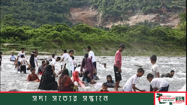 সিলেটের ভোলাগঞ্জ সাদাপাথরে শরতের রোদে পাহাড়ি নদীর স্বচ্ছ পানিতে নেমে পর্যটকদের আনন্দ ও গোসল করার দৃশ্য।