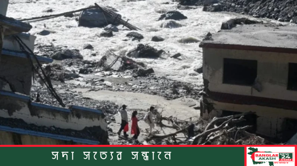 Devastated flood-affected area in Nepal with damaged infrastructure and muddy waters after severe flooding.